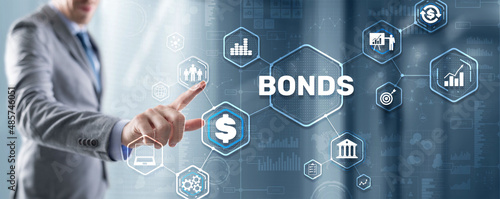 Businessman clicks a bonds virtual screen. Bond Finance Banking Technology concept. Trade Market Network photo