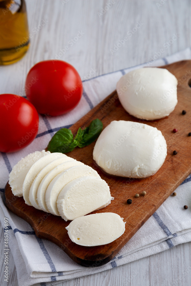 Homemade Mozzarella Cheese with Tomato, Basil and Olive Oil, side view.