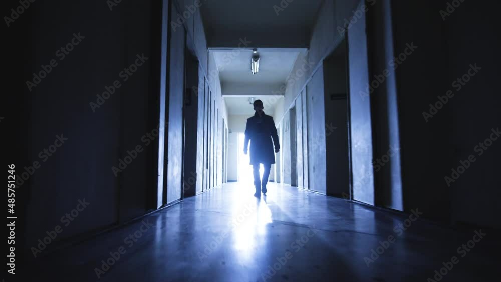 The handsome man looking for something in a dark corridor The handsome man looking for something in a dark corridor