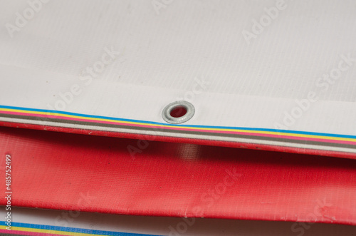 A red and white billboard. PVC fabric folded. Banner with eyelet