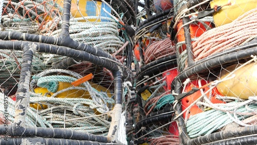 Traps, ropes and cages on pier, commercial dock, fishing industry, Monterey California USA. Empty pots, creels for fish seafood catching in port. Many fisherman's nets and baskets in seaport. Fishery.