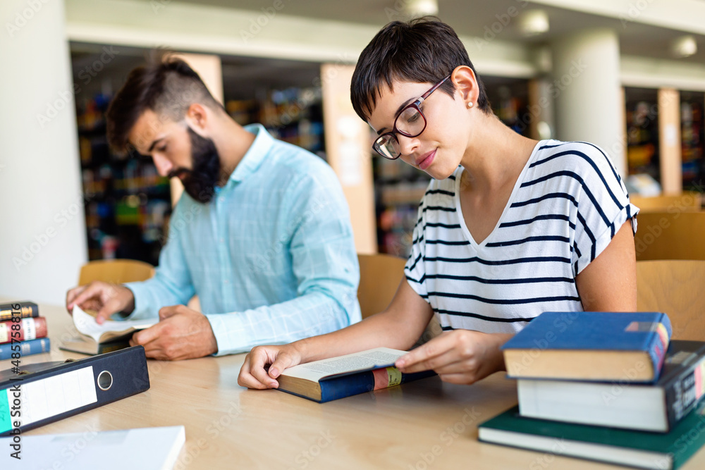 Happy group of students studying and working together in a college library Happy group of students studying and working together in a college library