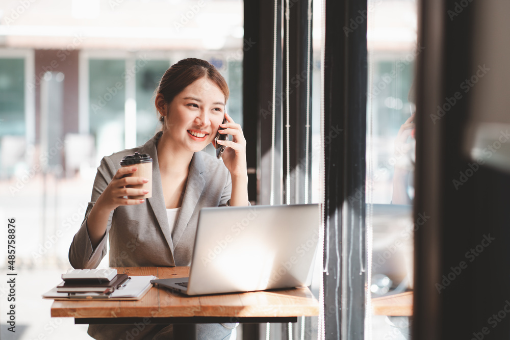 Young woman holding credit card and using laptop computer. Businesswoman working at home. Online shopping, e-commerce, internet banking, spending money, working from home concept Young woman holding credit card and using laptop computer. Businesswoman working at home. Online shopping, e-commerce, internet banking, spending money, working from home concept