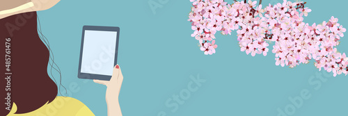 Back view of a woman looking at a tablet. cherry blossom branches, buds, vector illustration, banner, sign, poster, graphic, copy space, mockup