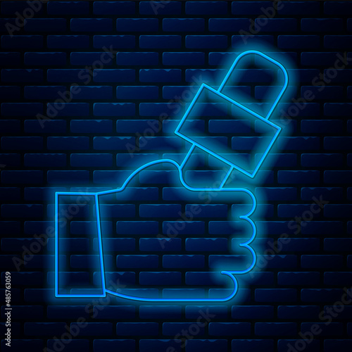 Glowing neon line Journalist hand holding microphones performing interview icon isolated on brick wall background. Vector