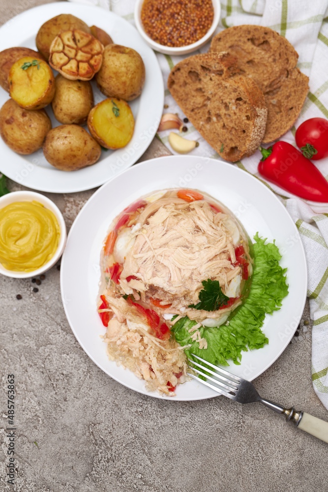 Delicious chicken aspic on a plate on concrete table