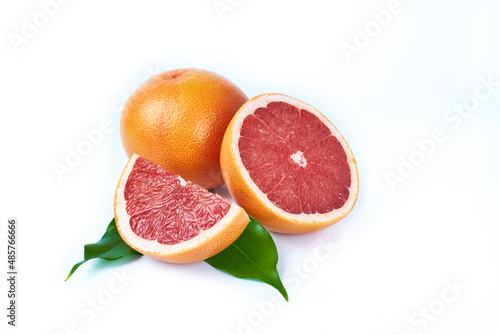 Red grapefruit whole and cut on white background