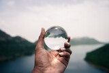 hand holding a glass globe