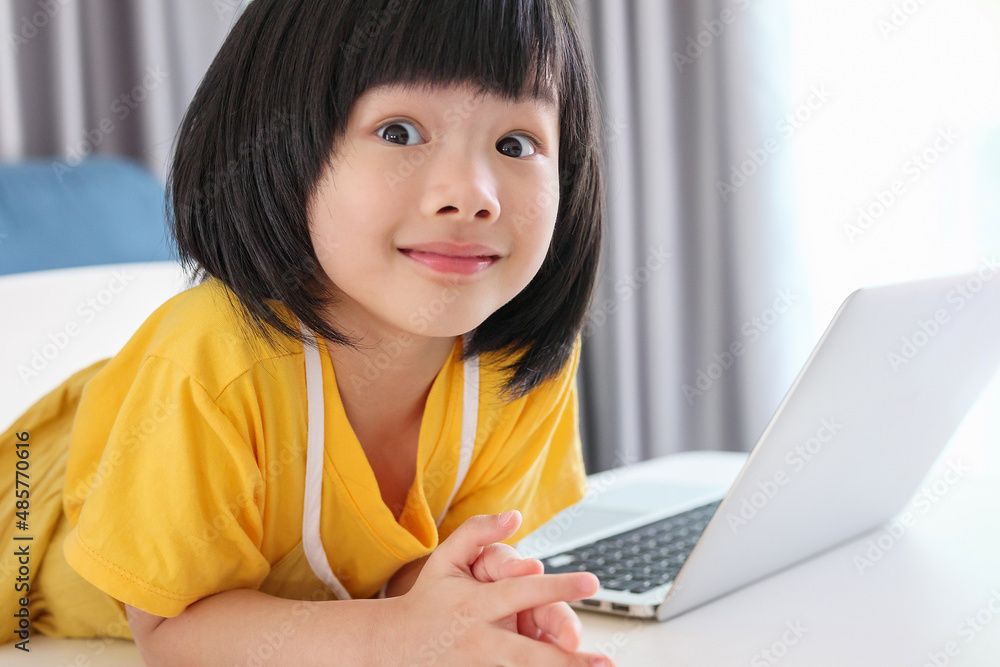 little asian girl student study online using laptop computer at home little asian girl student study online using laptop computer at home