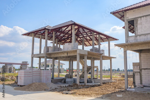 construction residential new house in progress at building site housing estate development © Piman Khrutmuang