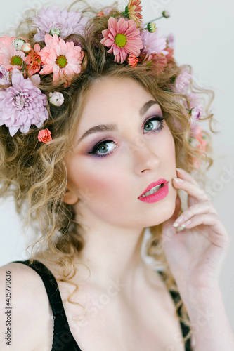 Beautiful blonde woman with flower wreath on her head. Spring. Womens Day