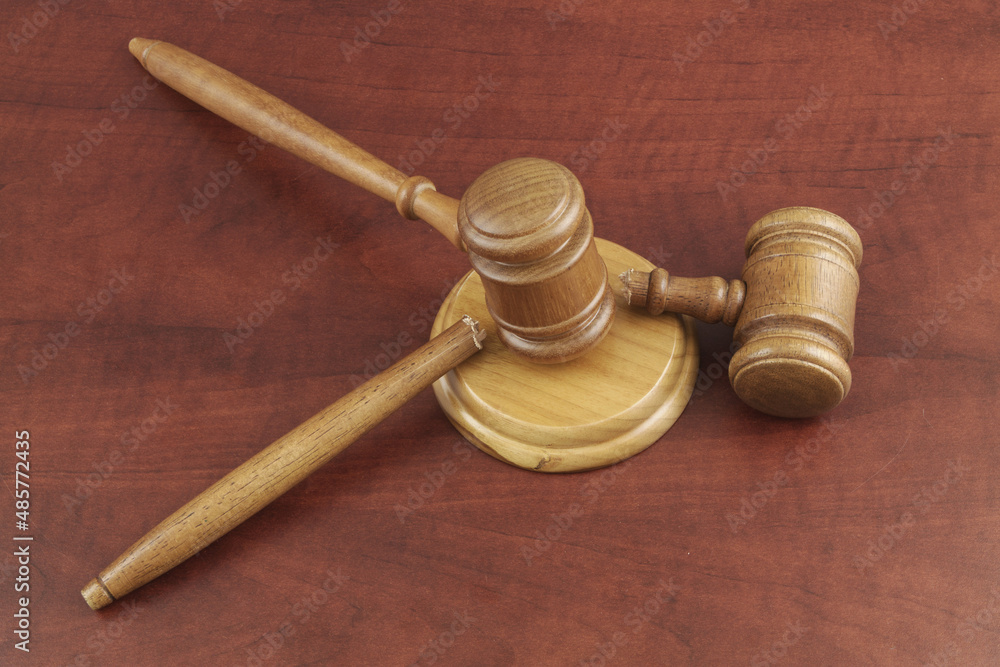 Laws cancelation concept. Two wooden gavels on table, one gavel broken. Laws cancelation concept. Two wooden gavels on table, one gavel broken.