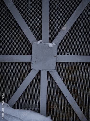 Texture of a gray metal grate with various elements
