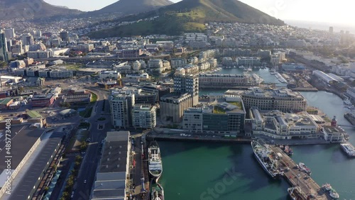 Aerial shot orbiting the around the harbor in Cape Town South Africa at sunset