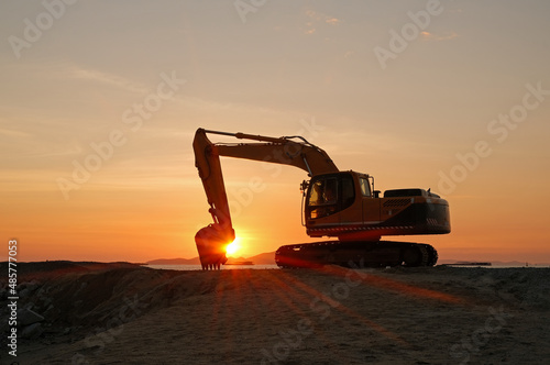 Beautiful tropical orange sunset with excavator