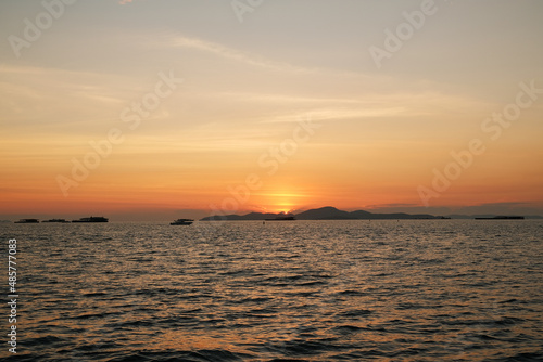 Beautiful tropical orange sunset at sea in Thailand