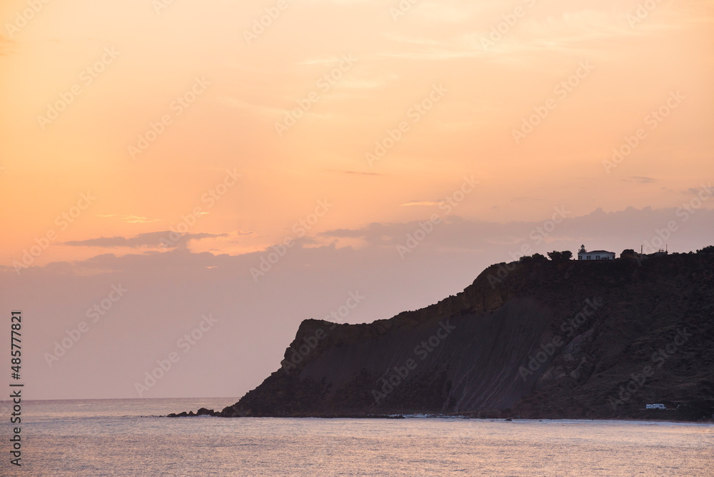 Sunset in Sicily, Rossello Cape lighthouse seen from Scala dei Turchi, Realmonte, Agrigento, Sicily, Italy, Europe