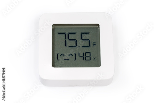 Digital indoor mini thermometer with hygrometer on a white surface photo