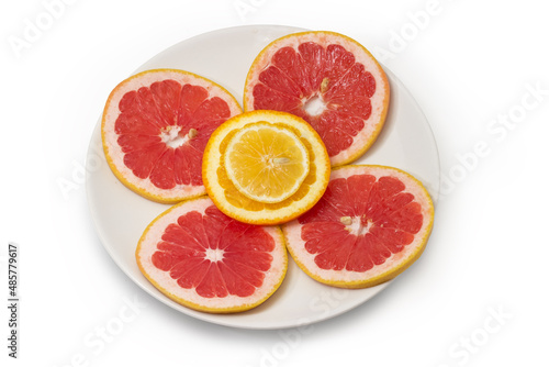 Round slices of the various citrus on a white dish