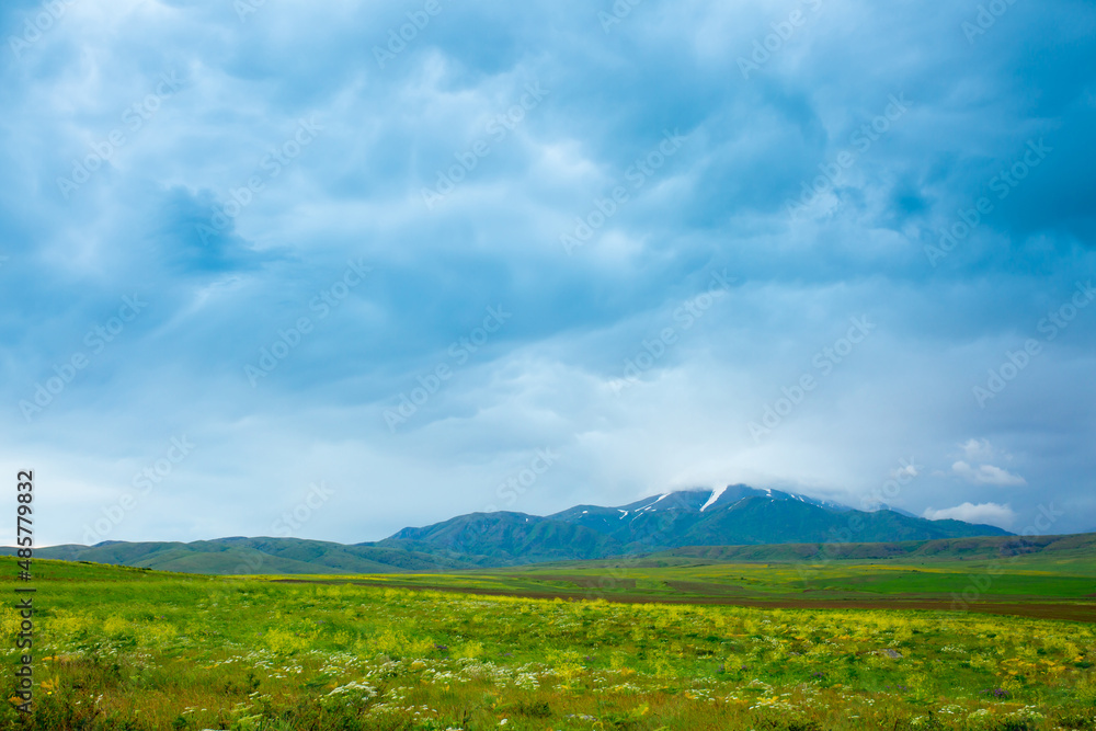 Panoramic view of the mountains in the distance, blue storm clouds over the mountains, cyclone, storm warning. Beautiful nature landscape. The freshness of the mountain air.