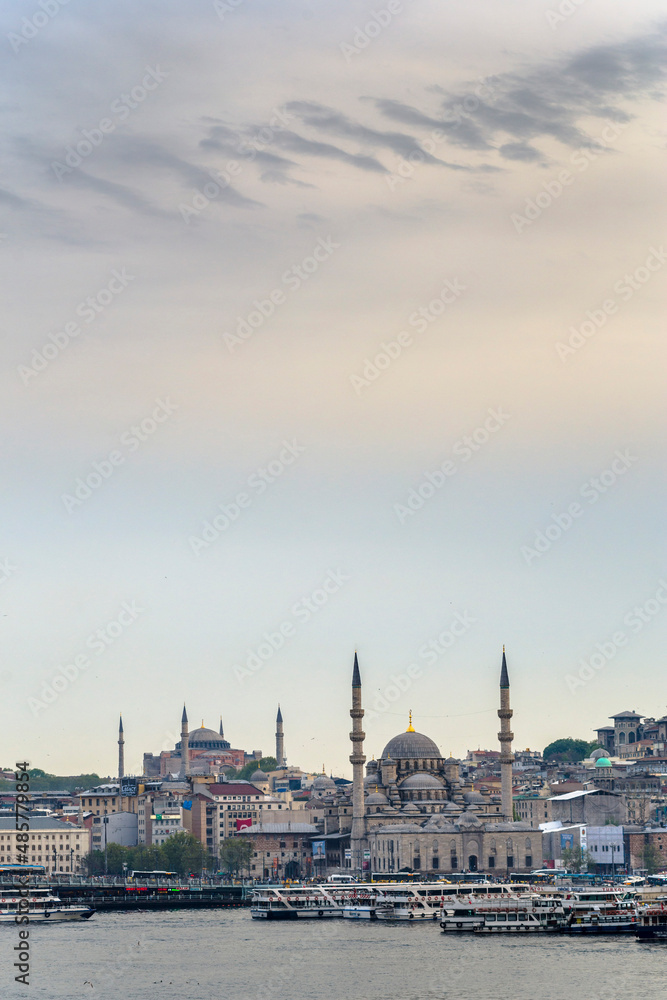 New Mosque (Yeni Cami) at sunset with Hagia Sophia (Aya Sofya) behind seen across the Golden Horn, Istanbul, Turkey, Eastern Europe