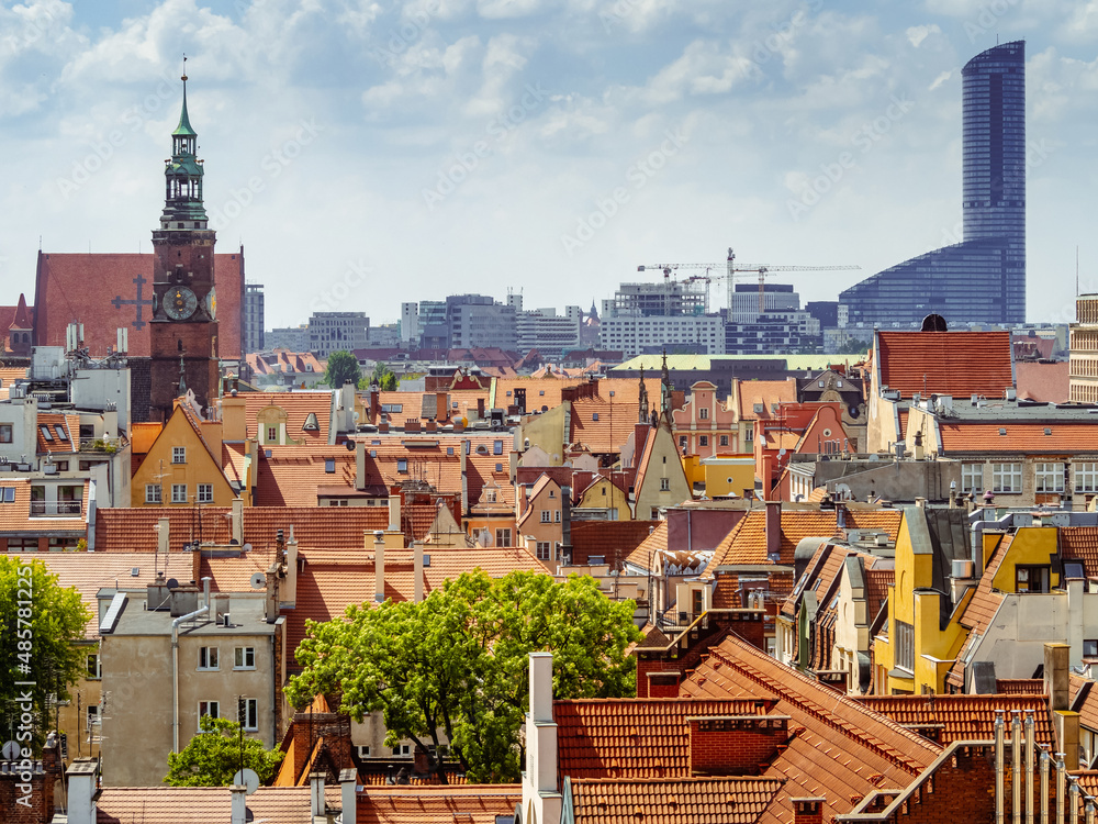 view from above on orange tiled rooftops of old medieval buildings of european polish city of Wroclaw