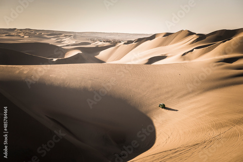 Dune buggying in sand dunes at sunset in the desert at Huacachina  Ica Region  Peru  South America