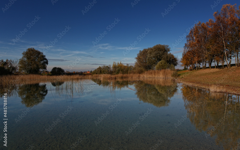 Perfect water reflection of a fishing lake in the autumn, fall. 