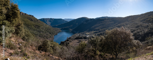 Panoramic view of the Serra da Encina da Lastra natural park, the Penarrubia reservoir surrounded by mountains and the Covas train station next to the town of Cobas de Valdeorras photo
