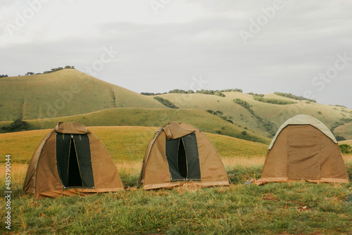 Scenic view of camping tents in the wild against mountains at Chyulu National Park, Kenya
