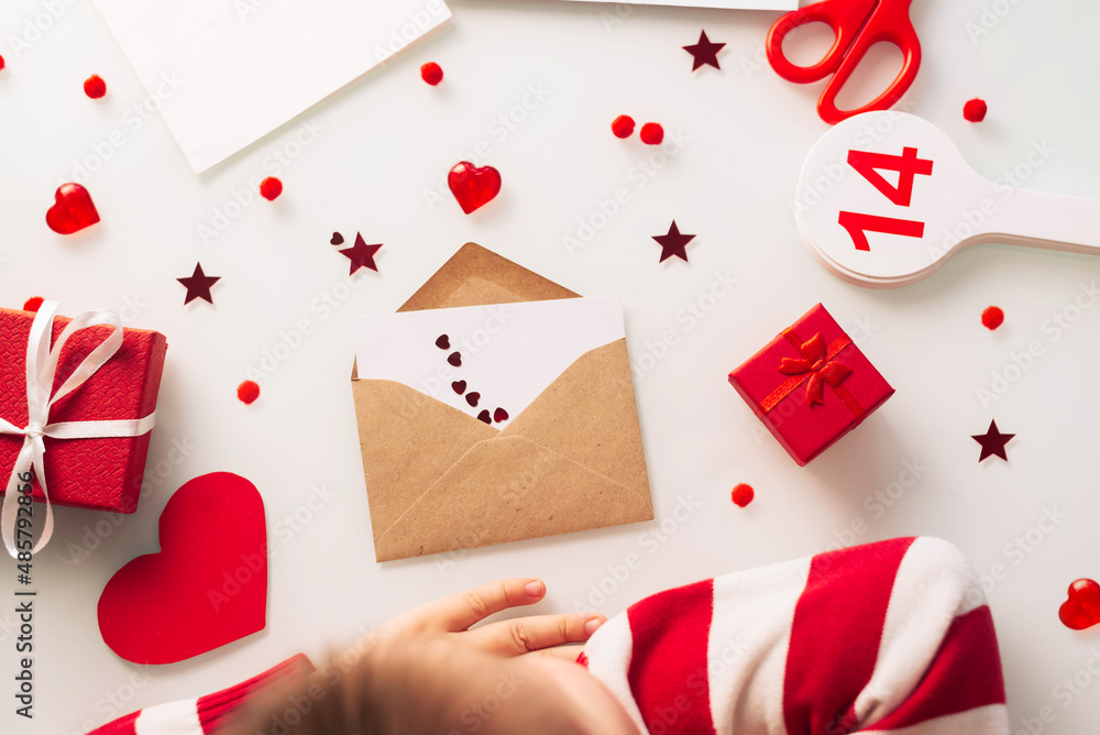 One happy child makes a gift with an envelope with a heart on Valentine's Day, to his mother on mother's day. One happy child makes a gift with an envelope with a heart on Valentine's Day, to his mother on mother's day.