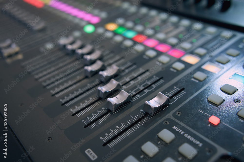Professional audio mixing console. Mixer. Pro audio mixing board faders and knobs. Static shot of multi-track music recording equipment faders and sliders. Professional audio mixing console. Mixer. Pro audio mixing board faders and knobs. Static shot of multi-track music recording equipment faders and sliders.