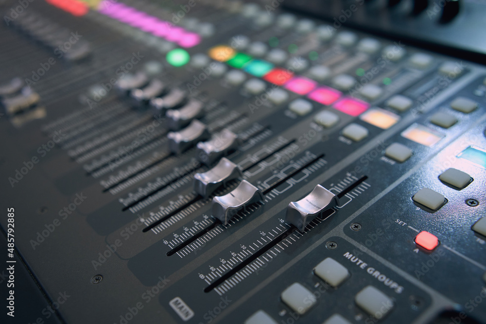 Professional audio mixing console. ​Mixer. Pro audio mixing board faders and knobs. Static shot of multi-track music recording equipment faders and sliders. 