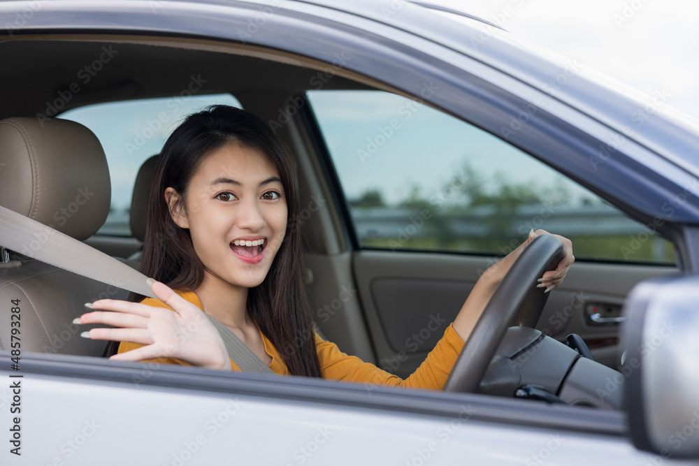 Wow. Young beautiful asian women getting new car. she very happy and excited. she sit and touching every detail of car. Smiling female driving vehicle on the road