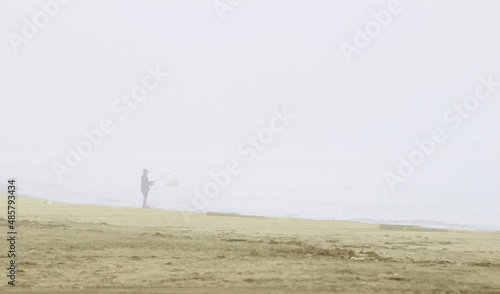 Photograph of fisherman in the morning mist. the beach of the Natural Park of Cabo de Gata, Almería, Andalusia, spain, tourism, tourist, advertising, travel, traveler, holidays, party, meet, tourist 
