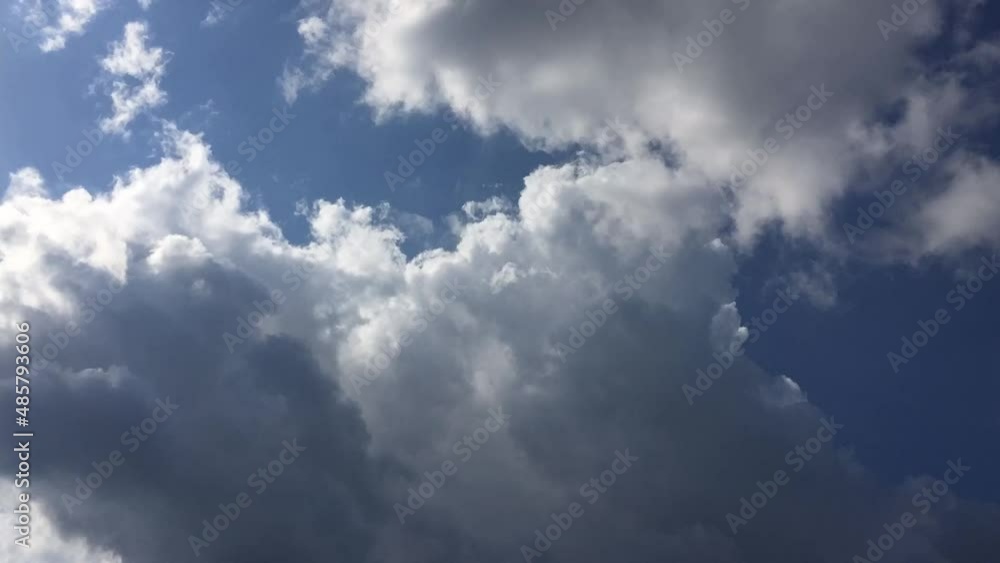 White cumulus clouds float across the sky. Fluffy cumulus clouds move quickly across the blue sky. Clouds on the go change their shape and size, appearing out of nowhere and dissolving in the air. White cumulus clouds float across the sky. Fluffy cumulus clouds move quickly across the blue sky. Clouds on the go change their shape and size, appearing out of nowhere and dissolving in the air.