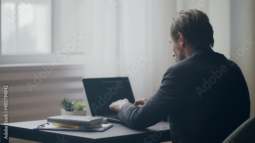 Wallpaper Mural Man in business suit typing on laptop in office, finishing work and closing pc Torontodigital.ca