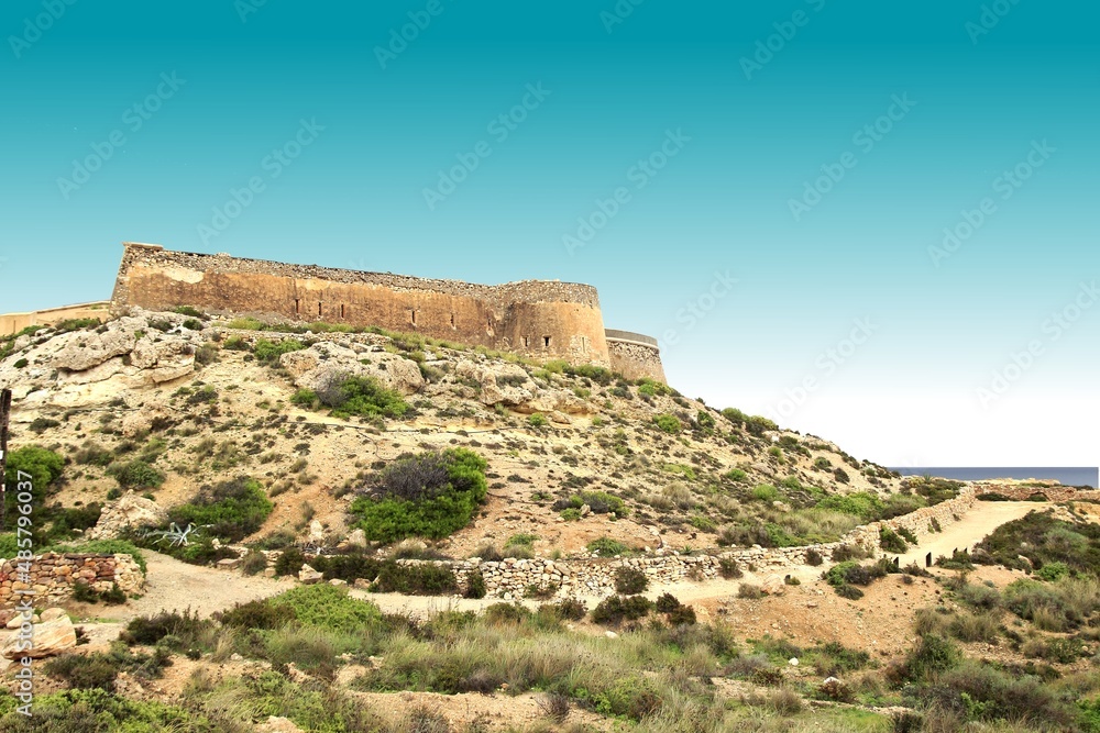 the fortress in the Playazo de Rodalquilar, Natural Park of Cabo de Gata, Almería, spain, Photo with space for advertising, blank space for your promotional text or advertising content,