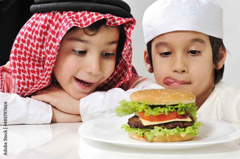 Middle eastern two little kids with big Burger Middle eastern two little kids with big Burger