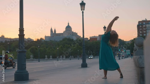 Woman dancing on the street at Sunrise in Madrid on a Bridge