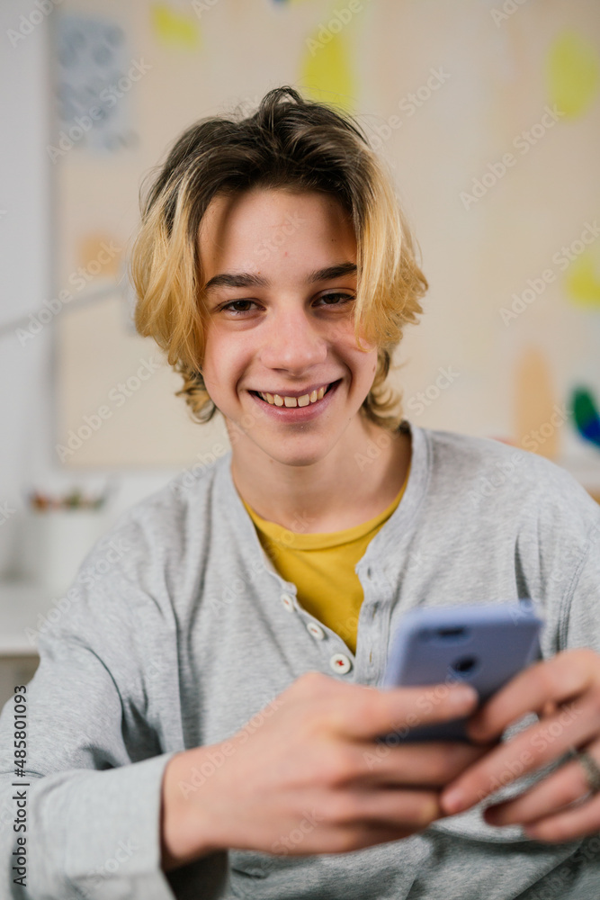 teenager using mobile phone at home teenager using mobile phone at home