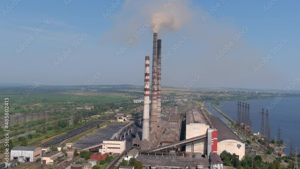 Gas turbine converts natural gas, other liquid fuels to mechanical energy. Aerial view of chimneys of power plant, an industrial district. Modern large thermal power plant. Working chp. Gas turbine converts natural gas, other liquid fuels to mechanical energy. Aerial view of chimneys of power plant, an industrial district. Modern large thermal power plant. Working chp.