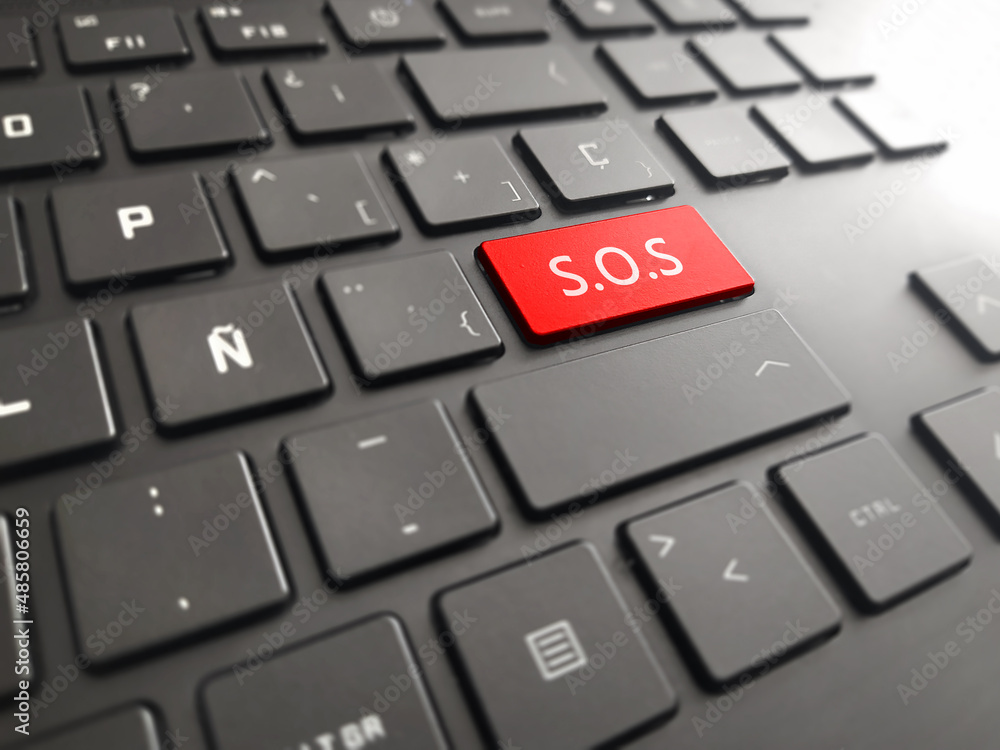 Keyboard with a big SOS. Picture of red button on the keyboard with word of help. Keyboard with a big SOS. Picture of red button on the keyboard with word of help.