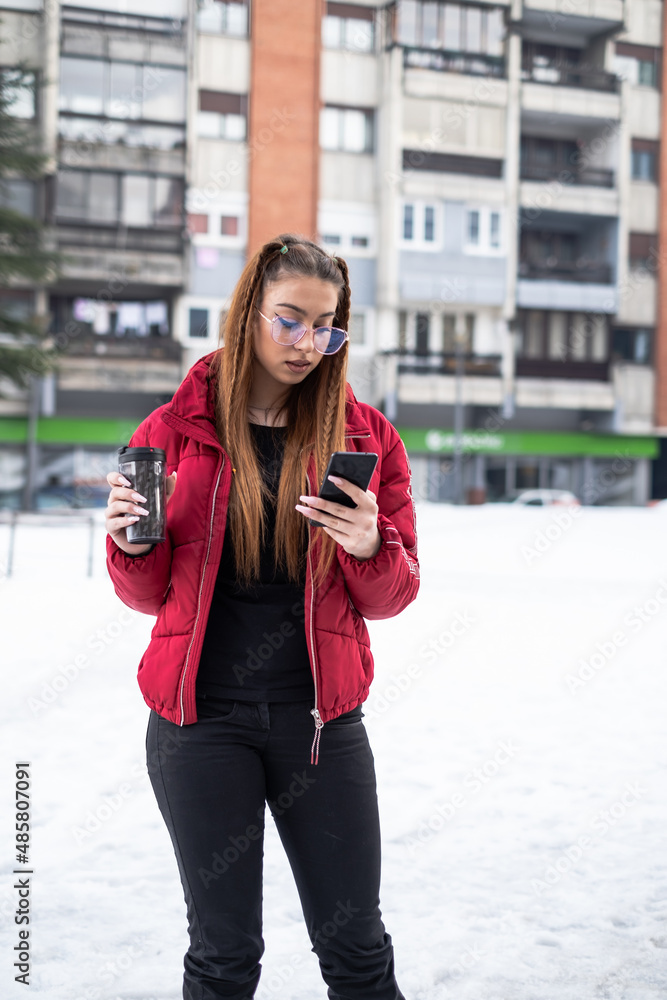 girl in her early twenties with a red jacket girl in her early twenties with a red jacket