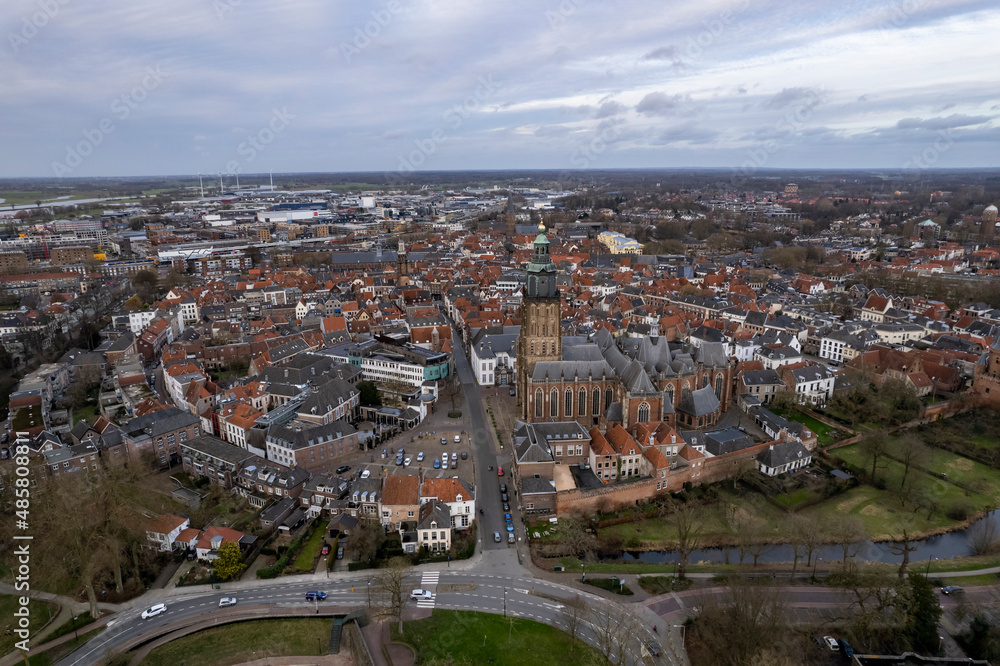 Picturesque aerial view of tower town Zutphen in The Netherlands with medieval Hanseatic city center on the river IJssel and highlighted Walburgiskerk. Panorama of Dutch settlement seen from above.