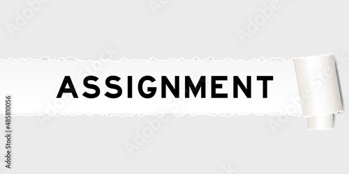 Ripped gray paper background that have word assignment under torn part