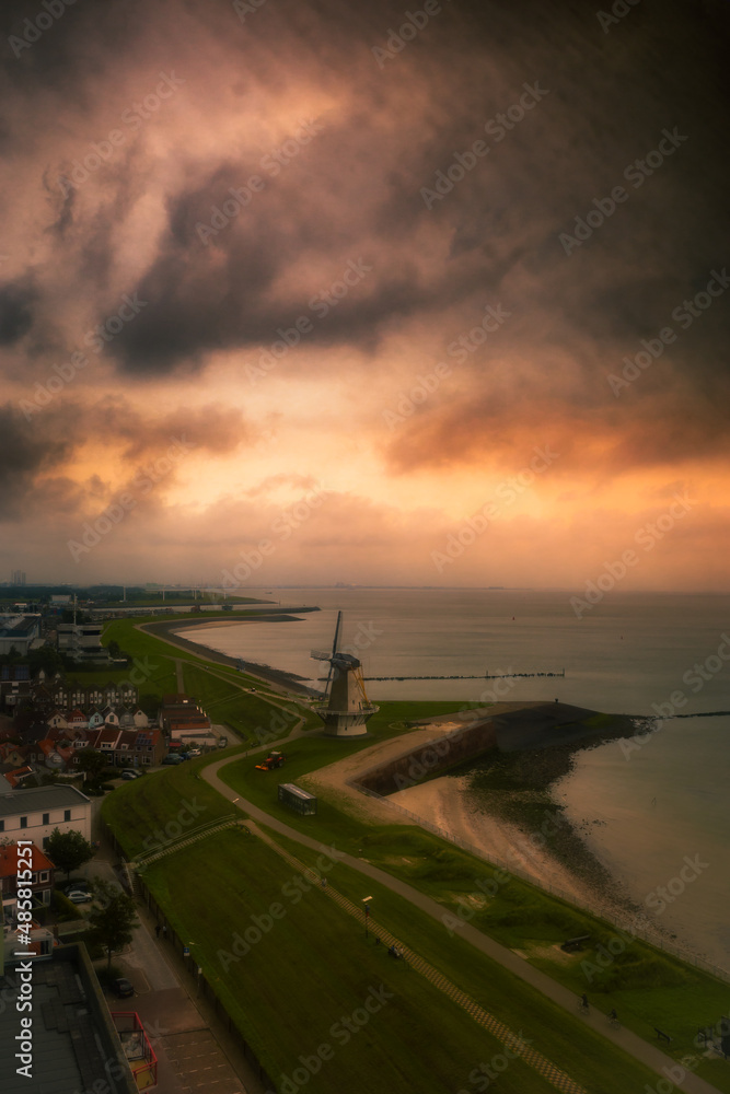 The coastline of the city of Vlissingen from the air during a storm and a sunset