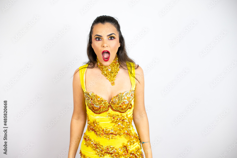 Young beautiful woman wearing carnival costume over isolated white background afraid and shocked with surprise and amazed expression, fear and excited face. Young beautiful woman wearing carnival costume over isolated white background afraid and shocked with surprise and amazed expression, fear and excited face.