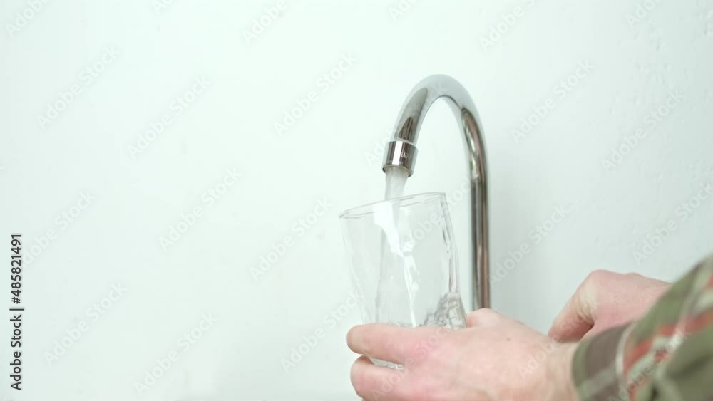 Close up video of pouring water from sink in glass. Close up video of pouring water from sink in glass.