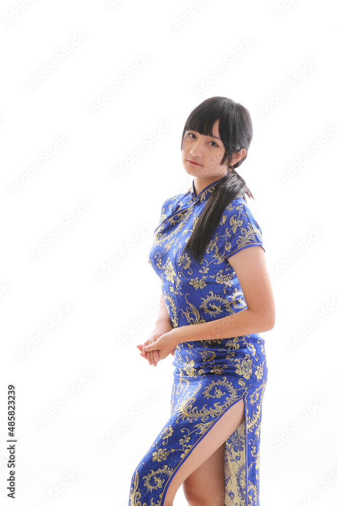 beauty woman wear blue cheongsam looking and smile in chinese new year beauty woman wear blue cheongsam looking and smile in chinese new year